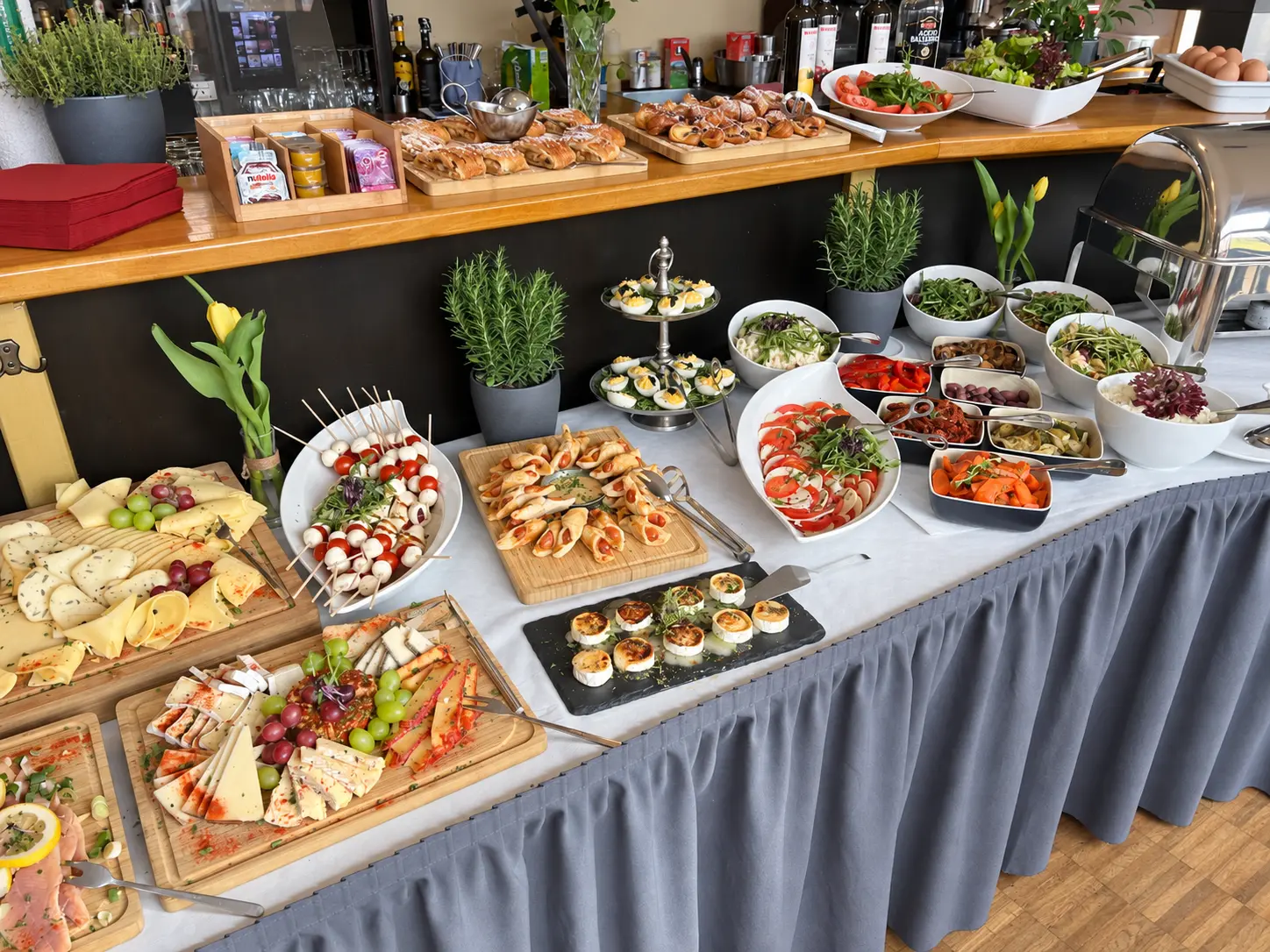 Festlich angerichtetes Buffet mit Käse, Fingerfood, Tomaten und Mozzarella, Salaten und süßem Gebäck